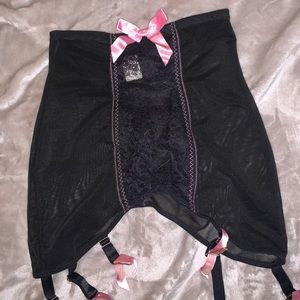 pink and black garter skirt by bettie page